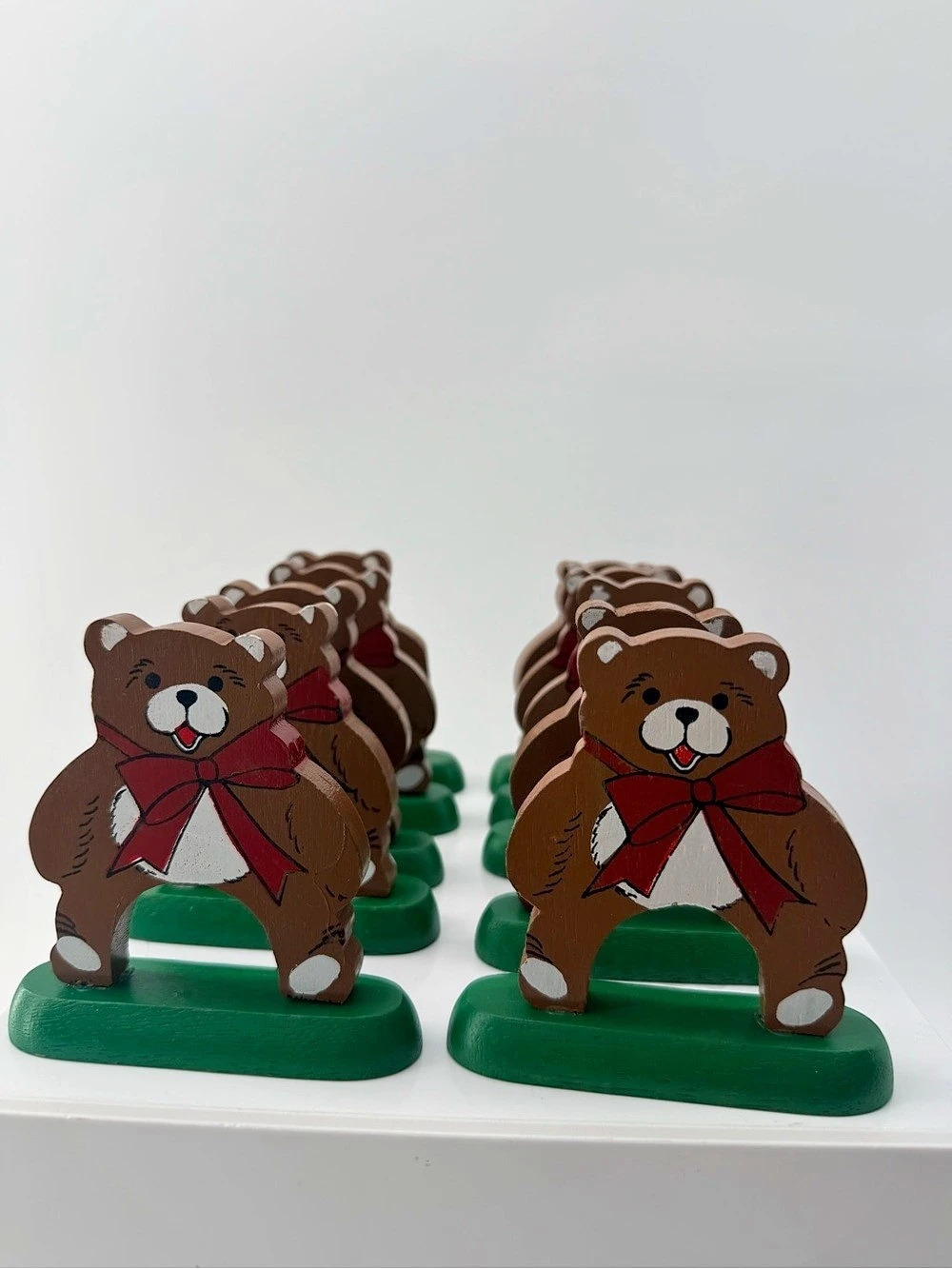 Hand - painted wooden teddy bear napkin holders on a green base - set of 10